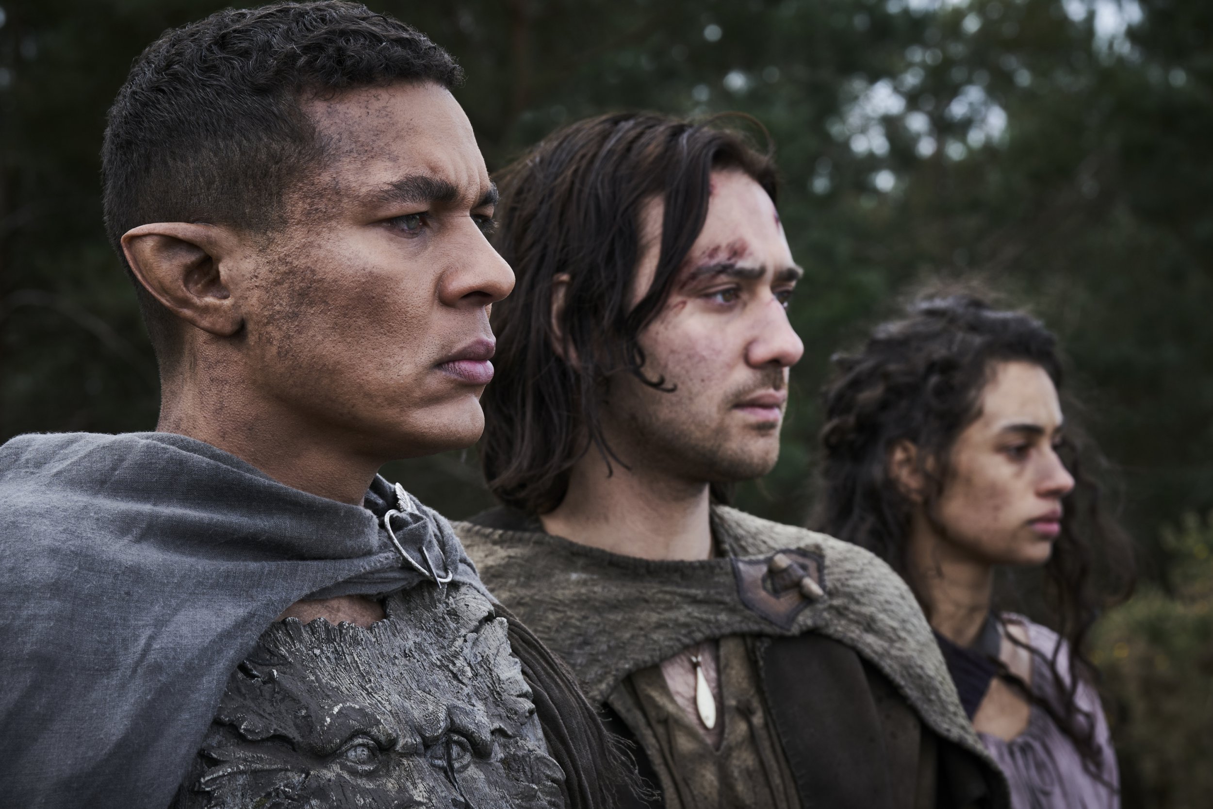 Ismael Cruz Cordova as Arondir; Maxim Baldry as Isildur; Nia Towle as Estrid in The Lord Of The Rings: The Rings Of Power